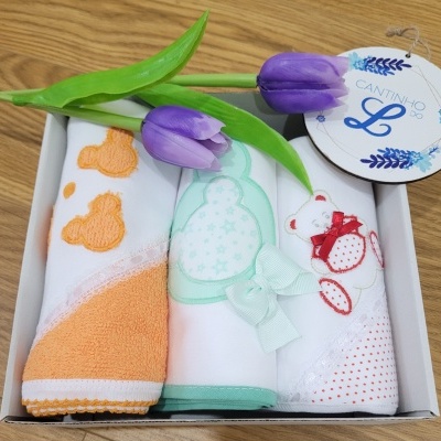 Três toalhas bordadas com ursinhos em caixa branca com flores tulipas roxas