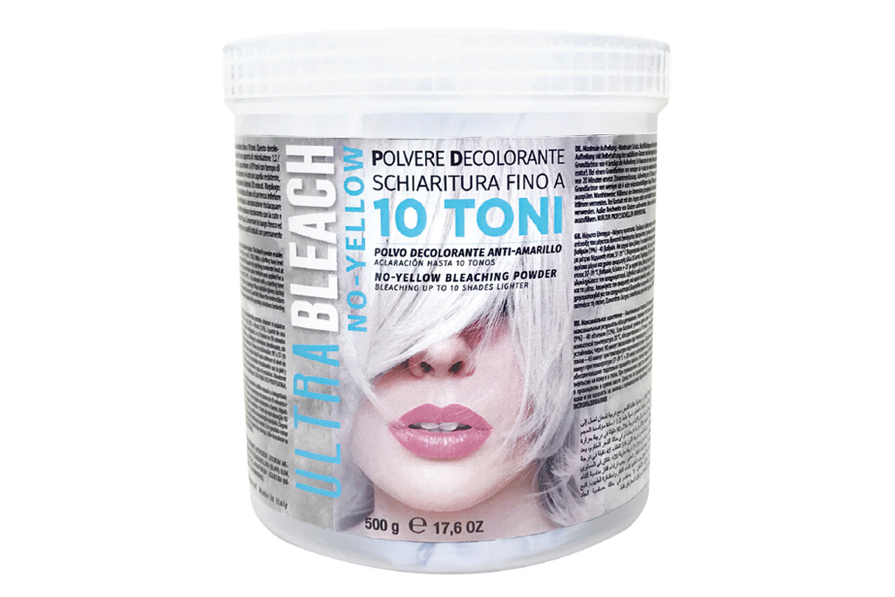 Pote branco de pó descolorante ULTRA BLEACH NO YELLOW com imagem de rosto feminino e texto multilíngue