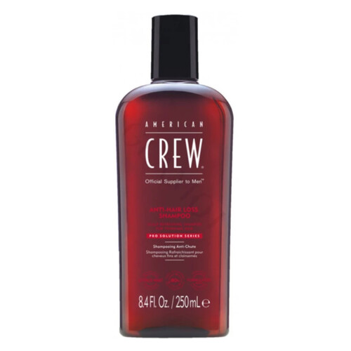 Frasco vermelho de champô American Crew com tampa preta