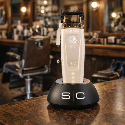 Como Escolher a Melhor Máquina de Corte Profissional para Barbearia (Guia para Barbeiros Experientes) Aparelho de barbear eletrónico prateado e preto numa base preta sobre mesa de madeira em salão de barbearia