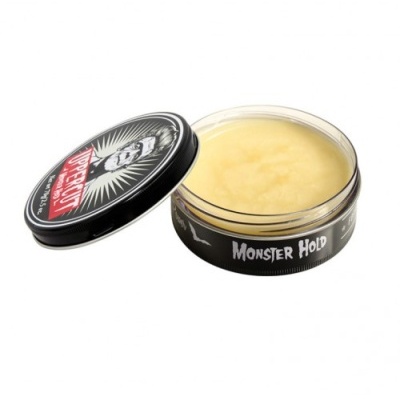 Pomada para cabelo Suavecito Monster Hold em embalagem preta aberta com conteúdo amarelo visível
