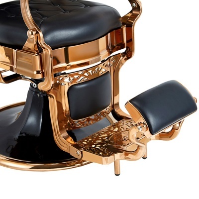 cadeira de barbearia dourada com estofado preto