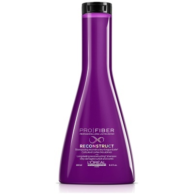 Frasco de champô roxo L'Oréal Pro Fiber com tampa preta e texto branco