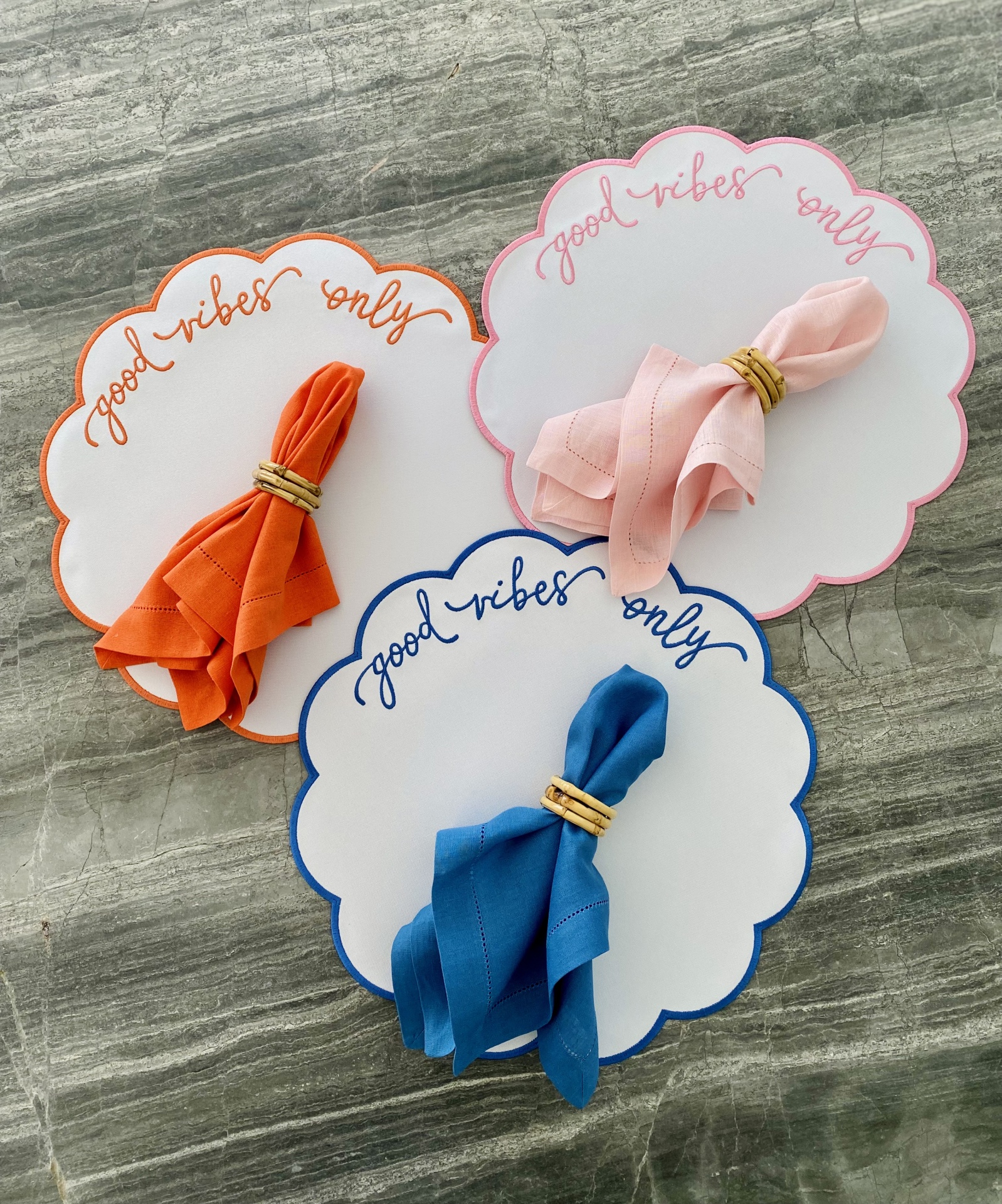 Panos de tecido coloridos com argolas de bambu em placas com a frase 'good vibes only'