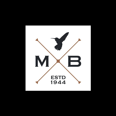 Logótipo com duas flechas cruzadas, letras M e B, beija-flor e texto ESTD 1944