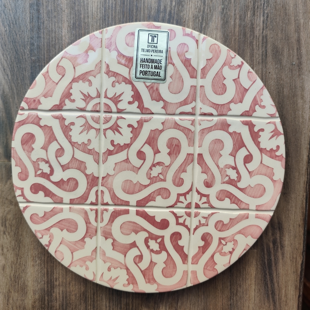 Prato redondo em cerâmica com padrão ornamental vermelho e creme dividido em azulejos com etiqueta