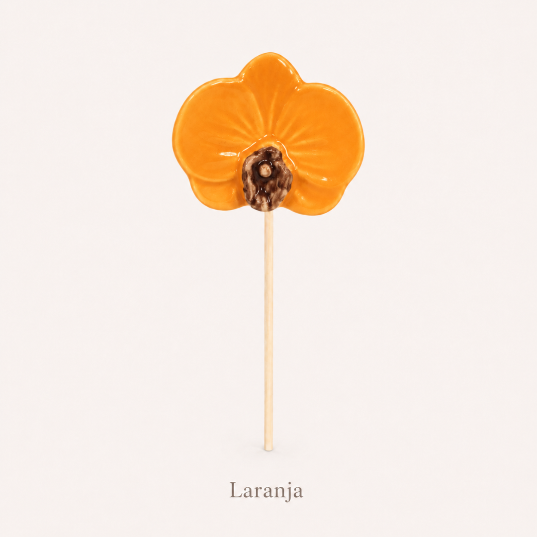 Pirulito em forma de flor laranja com pau de madeira