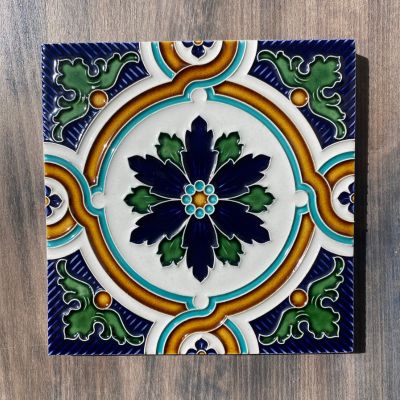 Azulejo cerâmico quadrado com padrão floral em azul, verde e amarelo