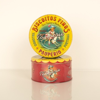 Duas latas metálicas coloridas para biscoitos, uma amarela em cima e uma vermelha em baixo, decoradas com imagem de criança e texto em português.