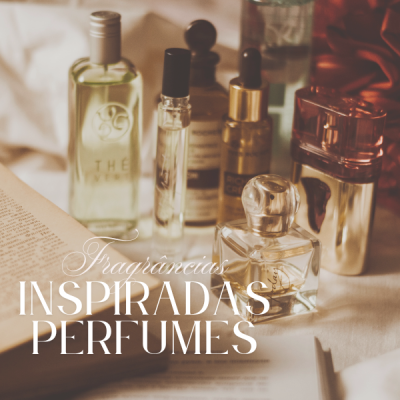 Vários frascos de perfumes e fragrâncias sobre superfície clara ao lado de livro aberto