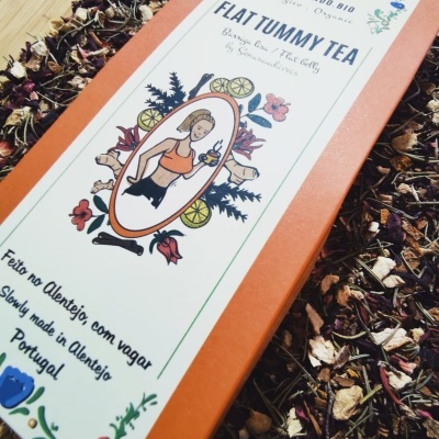 Embalagem de chá Flat Tummy Tea com ilustrações e texto sobre folhas secas