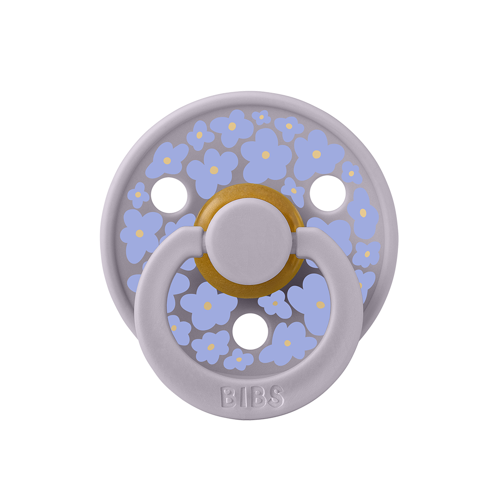 BIBS COLOUR | STUDIO EDITION Chupeta com padrão de flores lilás e amarelas com anel branco e botão amarelo