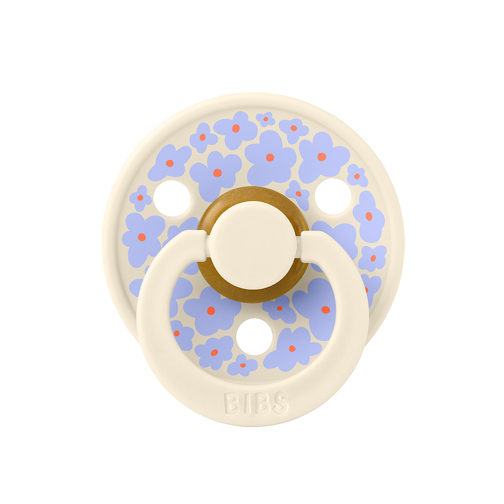BIBS COLOUR | STUDIO EDITION Chupeta BIBS com flores azuis e vermelhas em fundo creme