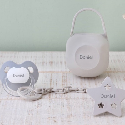 Chupeta azul, corrente plástica e suporte branco com nome Daniel