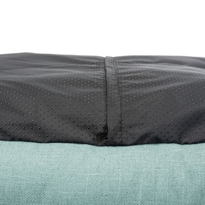 Capa preta com relevo pontilhado e fecho de correr sobre tecido azul claro