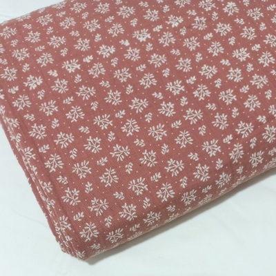 Musselina com raminhos brancos em fundo barro