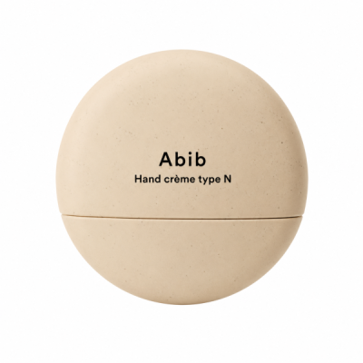 Embalagem redonda bege fosca com texto Abib Hand crème type N