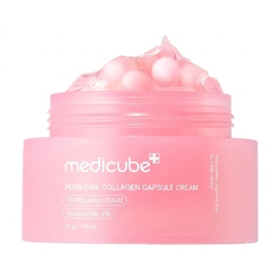 Frasco rosa com creme e cápsulas visíveis