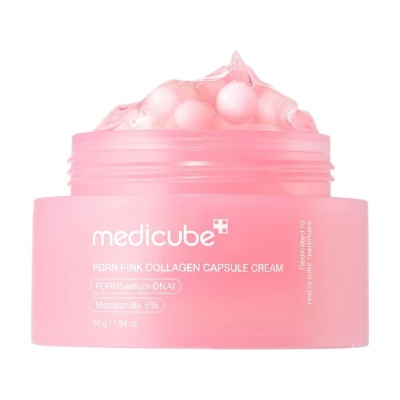 Frasco rosa com creme e cápsulas visíveis