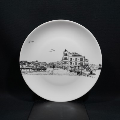 Prato branco com desenho preto de casas de praia e aves no céu