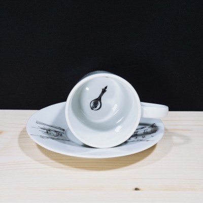 Chávena branca com desenho de guitarra e prato com pautas musicais pretas