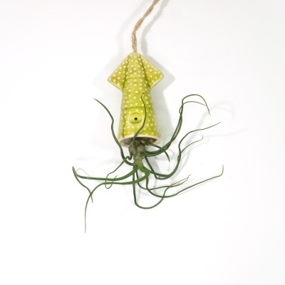 Ornamento suspenso em forma de lula verde com bolinhas brancas e planta artificial