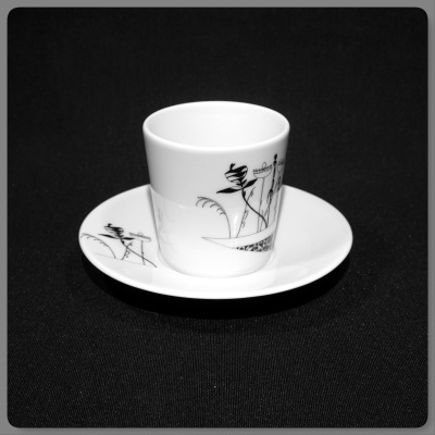 chávena e pires em porcelana branca com decoração preta de flores