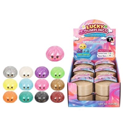 Brinquedos sensoriais Lucky Dumplings em várias cores com carinhas sorridentes e caixa colorida