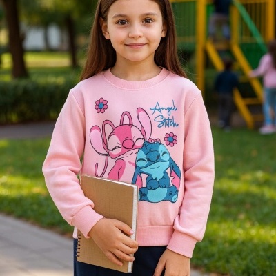 Camisola rosa com estampado Angel Stitch usada por criança com caderno castanho no parque