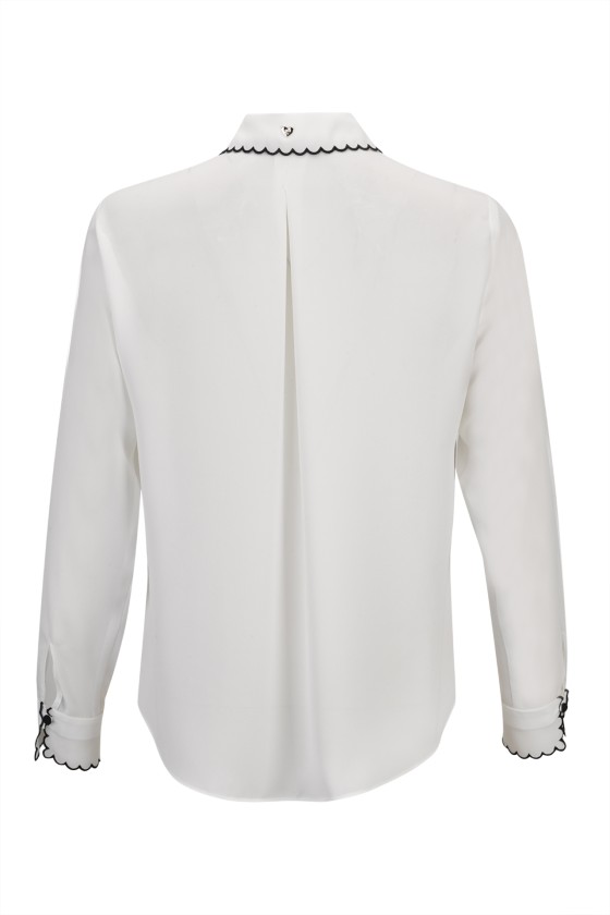 Camisa branca de manga comprida com detalhe preto na gola e punhos