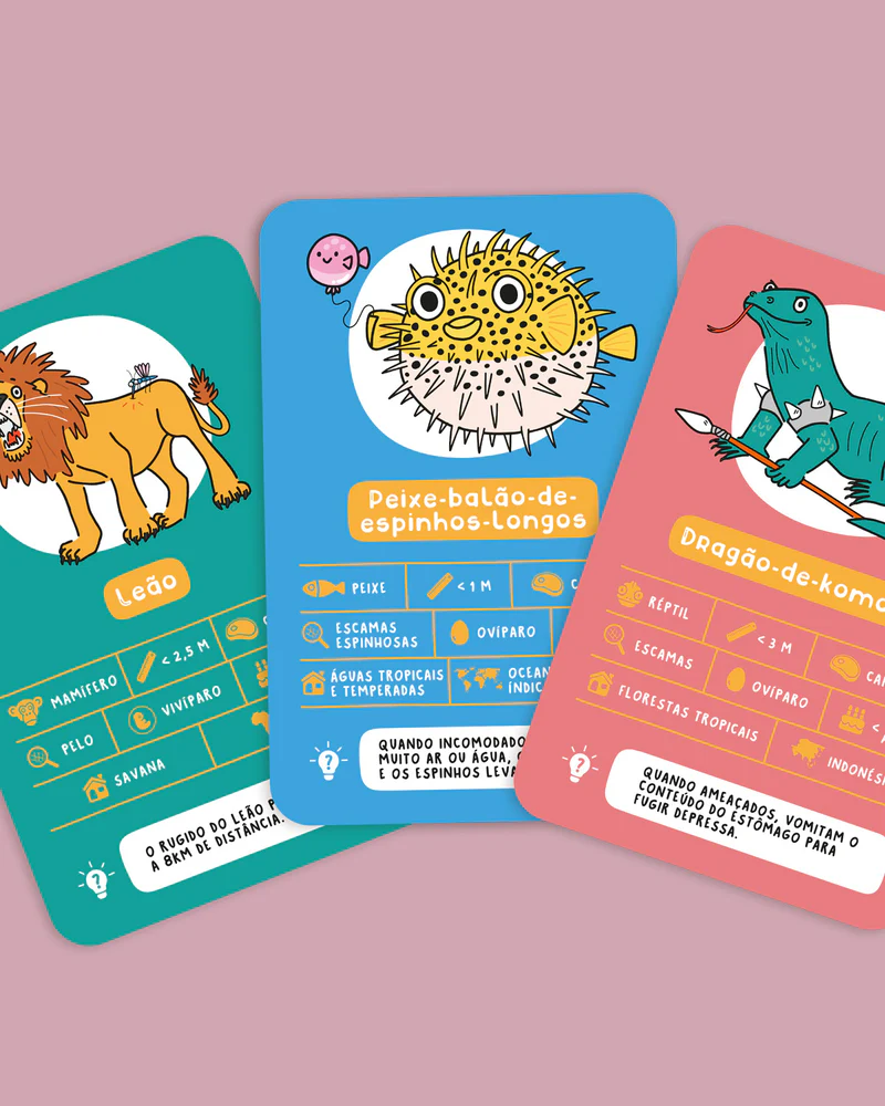 Vamos Jogar aos Animais! Três cartas coloridas com desenhos de um leão, peixe-baião-de-espinhos-longos e dragão-de-komodo com textos informativos em português.