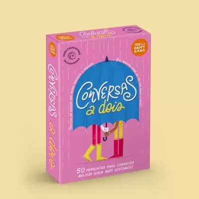 Embalagem rosa do jogo Conversas a dois com ilustração de duas pessoas sob guarda-chuva azul
