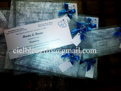 Convite de casamento cinzento com laços azuis e texto visível Marta & Brune e Francisco