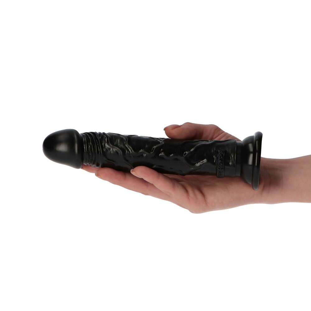 Dildo preto texturizado em forma de falo segurado por mão