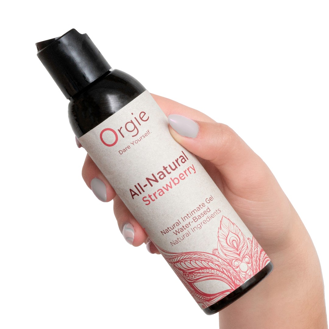 Frasco com rótulo de gel íntimo natural morango sendo segurado por mão feminina