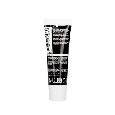 Frasco pequeno branco com rótulo preto e texto em branco e verde
