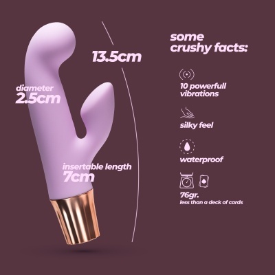 Vibrador lilás com base dourada e texto sobre características técnicas.
