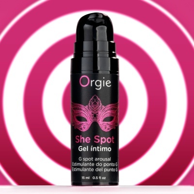 Frasco de gel íntimo preto com rótulo e máscara cor de rosa em fundo branco com círculos cor de rosa