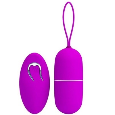 Produto em silicone roxo com duas peças ovais, uma com botão prata e outra com cordão de silicone