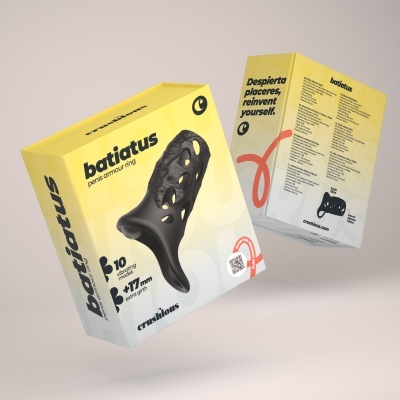 Embalagem amarela de anel preto com furos para o pénis com texto descritivo.