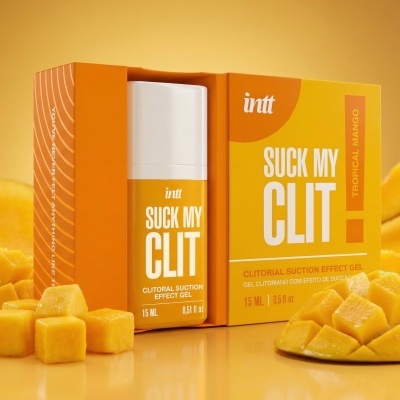 Gel clitoriano intt Suck My Clit Tropical Mango com frutas de manga frescas e fatias, embalagem laranja e branca.