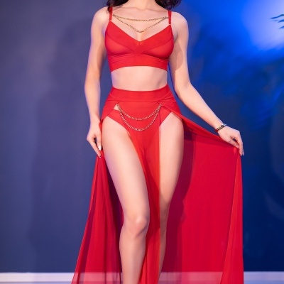 Conjunto feminino vermelho com top, saia longa transparente e sandálias nude.