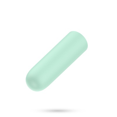 Cápsula de medicamento verde clara em fundo branco