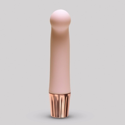 Produto cylindrical nude com base metálica dourada sobre fundo cinza