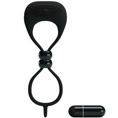 Elástico preto com duas bolas ao centro e pequeno objeto cilíndrico preto sobre fundo branco.