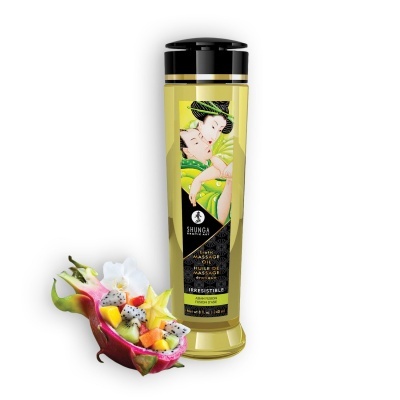 Frasco de óleo de massagem erótico Shunga com rótulo ilustrado e meio fruto do dragão recheado com mistura de frutas.