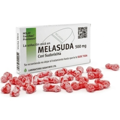 Caixa de medicamento Melasuda 500 mg com pastilhas vermelhas em frente