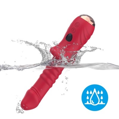 Vibrador vermelho com botão preto submerso em água com ícone azul à prova de água.