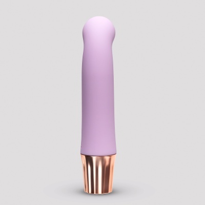 Vibrador roxo com base dourada metálica e topo arredondado, fundo cinzento