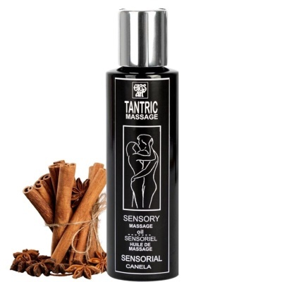 Garrafa preta de óleo para massagem com rótulo branco e paus de canela ao lado